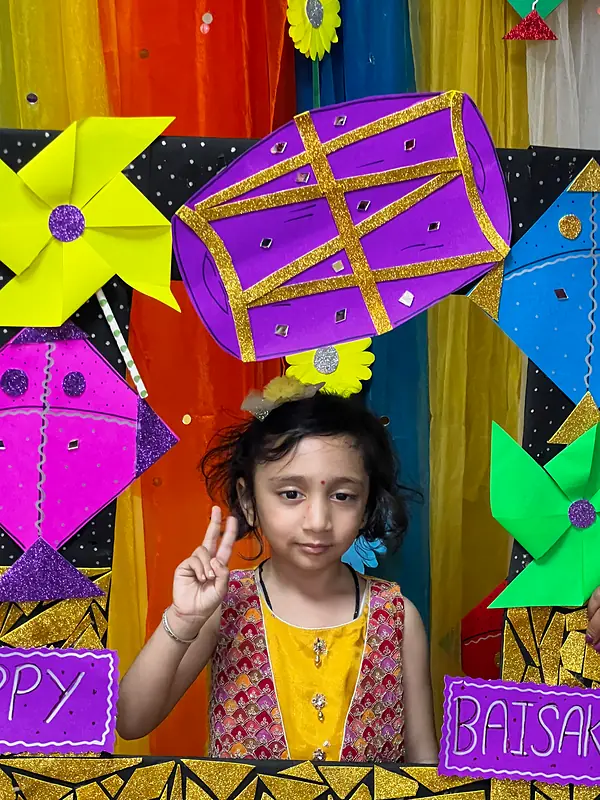 A girl waving from the Happy Baisakhi photo frame