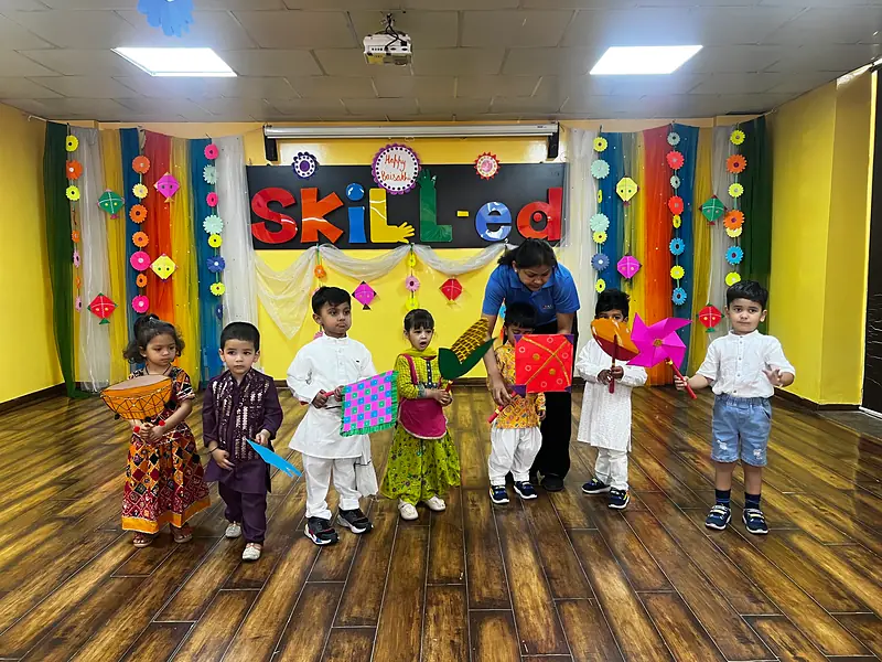 Children in festive outfits on stage in the Skill-ed activity hall