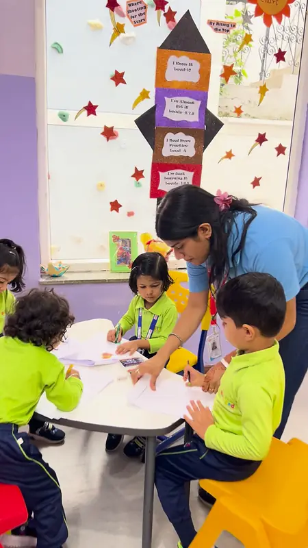 A teacher guides a boy's pencil during writing practice