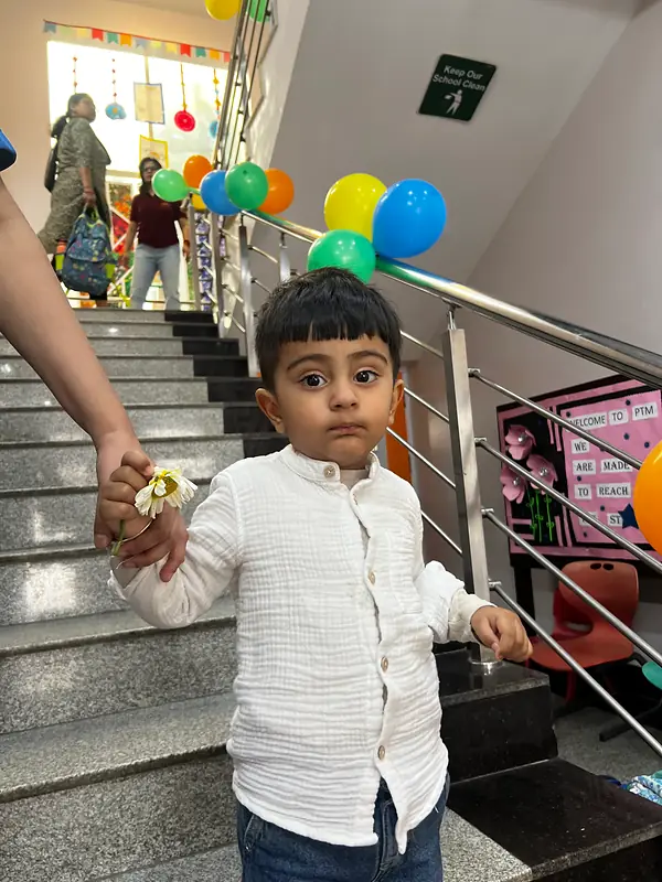 A young child arriving hand in hand on the first day of school