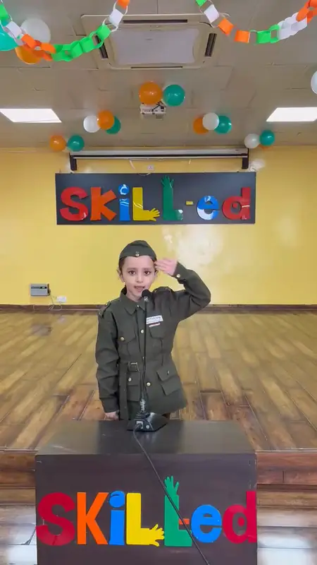 A boy in army uniform salutes at the podium