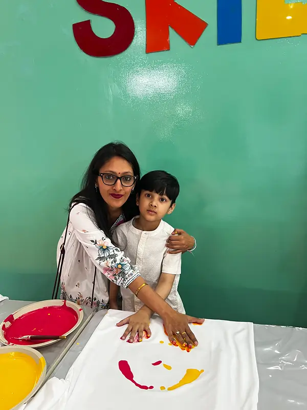 A mother and son make handprints together on Mother's Day