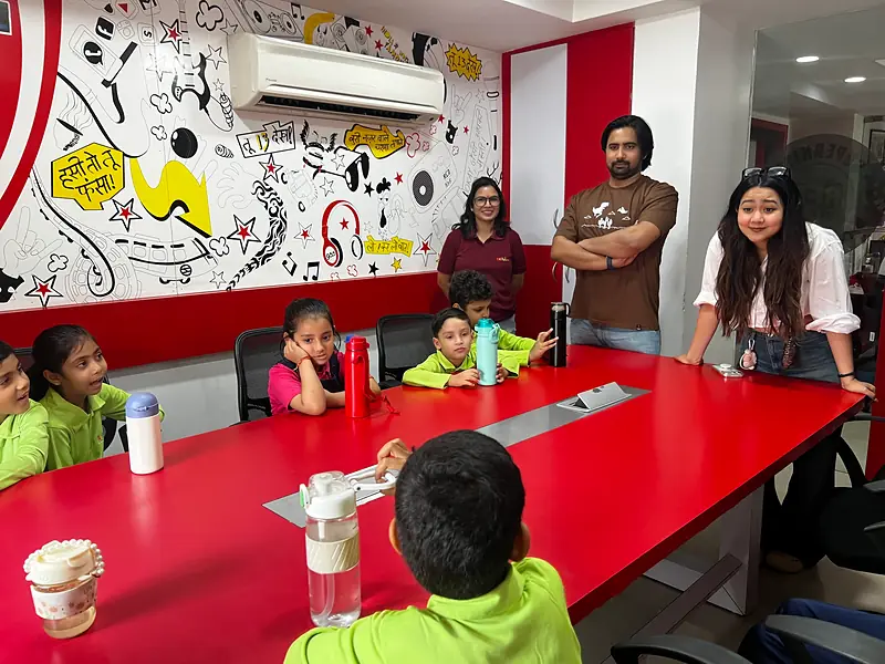 Students chatting with radio jockeys at RED FM 93.5