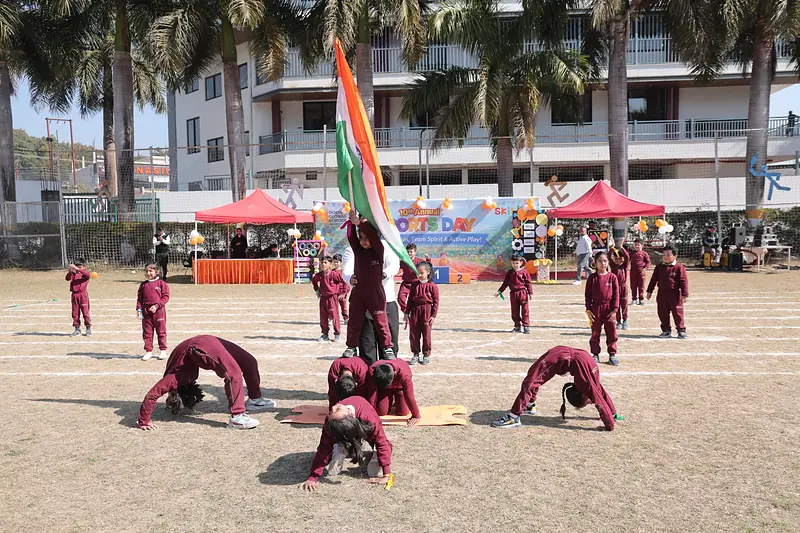 Students perform a drill display around the national flag