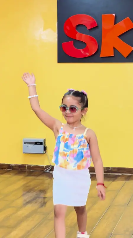 A girl in sunglasses strikes a pose at the welcome party