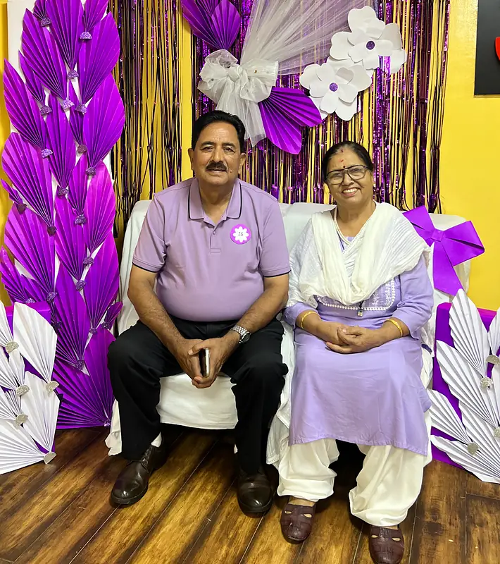 Grandparents at the purple flower booth on Grandparents Day