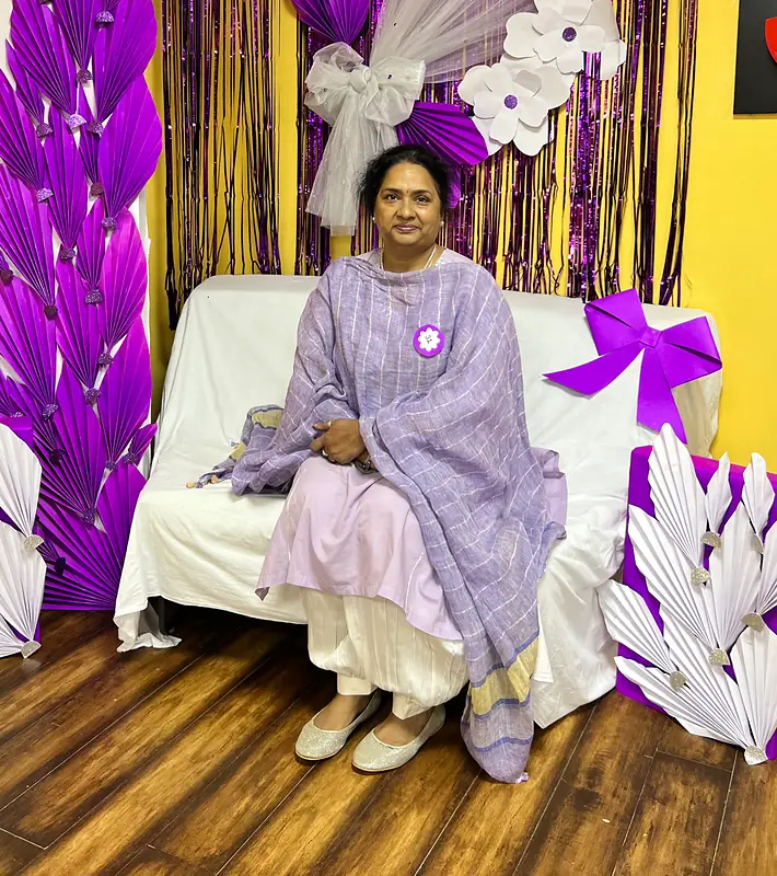 Grandparents at the purple flower booth on Grandparents Day