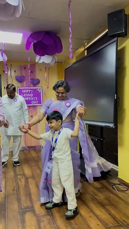 A grandmother spins her grandson during the family dance