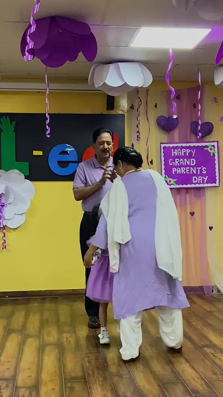 Grandparents and a granddaughter dance together