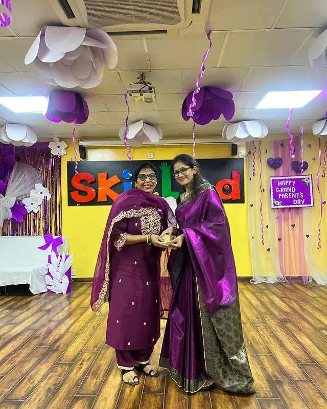 A grandmother receives a trophy at the felicitation
