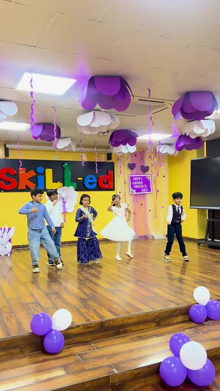 Children perform a group dance for their grandparents